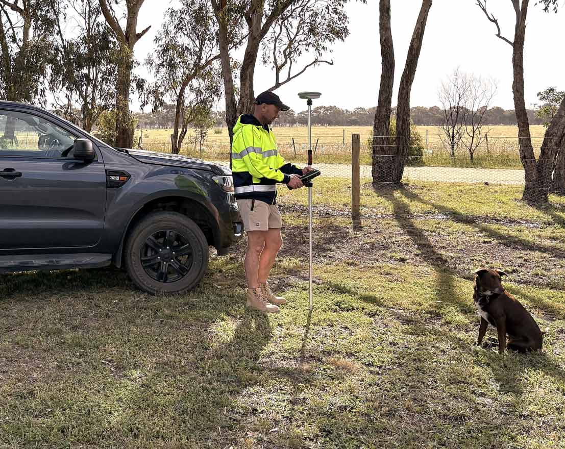 Mark Potter, Geelong land surveyor with his dog